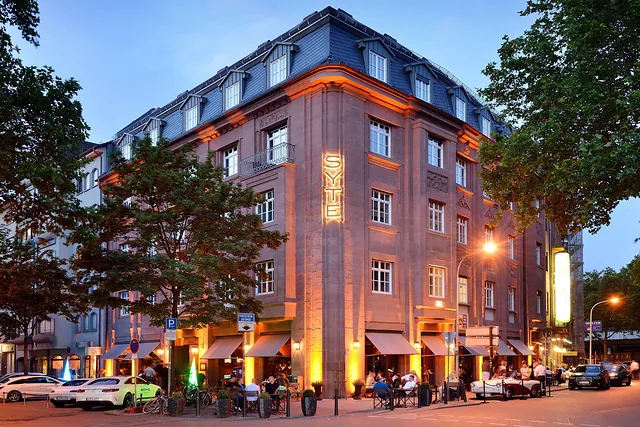 Finished hotel building at dusk with illuminated facade