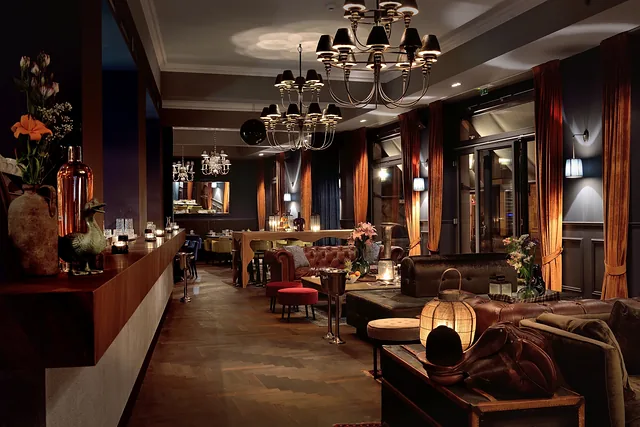 Finished lounge with chandeliers, timber floor and warm lighting