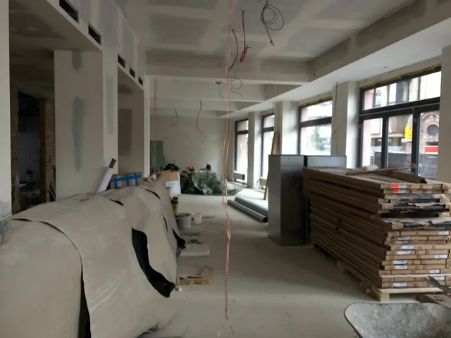 Future restaurant area in shell state with window front and stacked materials
